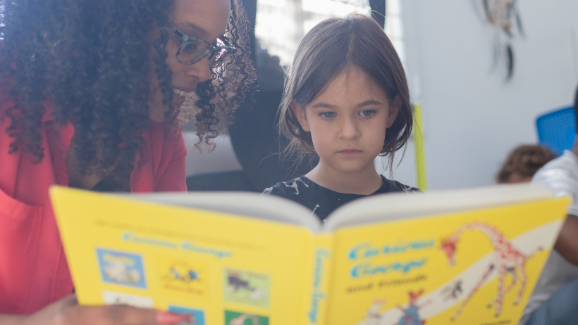 Child Reading with Teacher.